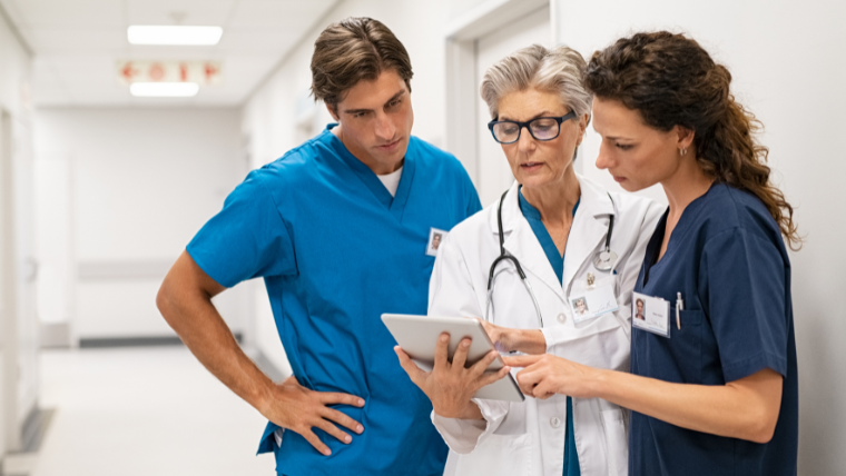 Hospital case manager coordinating patient transport from workstation