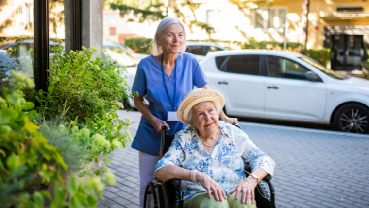 Assisting a nursing home resident with wheelchair handoff at the facility entrance