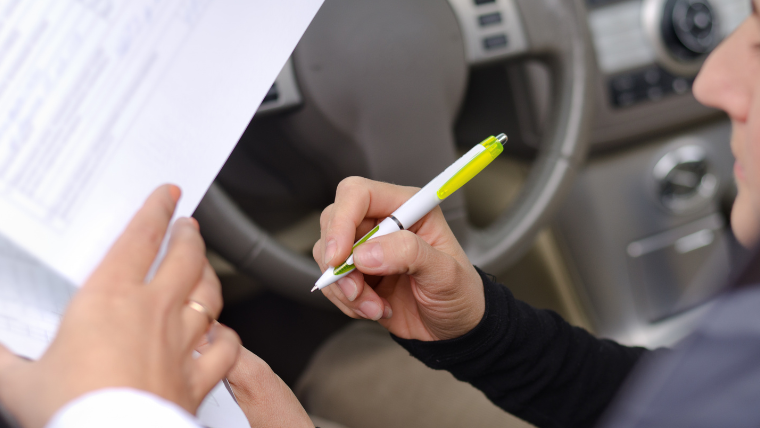 NEMT driver documenting patient handoff with facility staff at destination