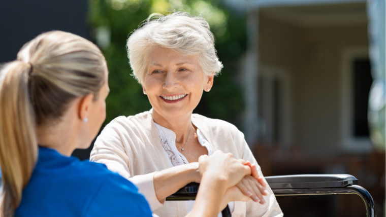 Nurse helping elderly woman with mobility support in a South Florida home