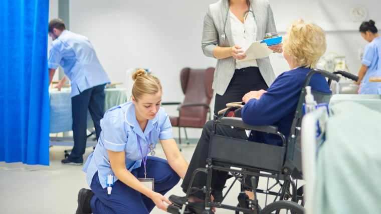 Patient reviewing discharge paperwork with a caregiver after outpatient surgery