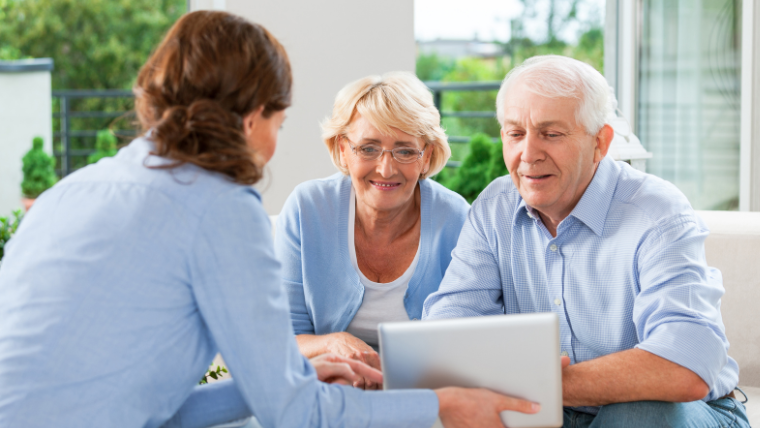 Senior couple reviewing transportation options on tablet with adult daughter