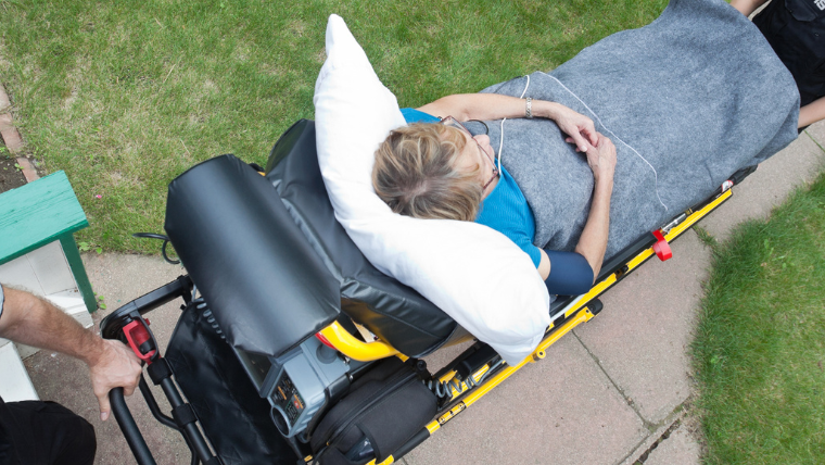 Interior of a Jano Med-Ride stretcher van showing a floor-mounted medical cot with restraints and adjustable head